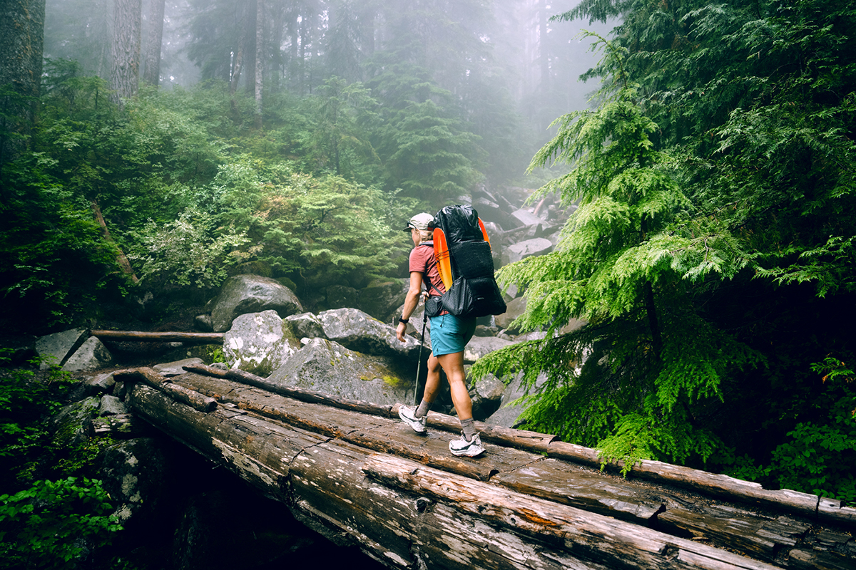 Hyperlite Unbound 55 backpack (hiking along wet bridge)